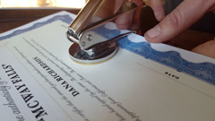 Artist Dana Richardson embossing her certificates of authenticity